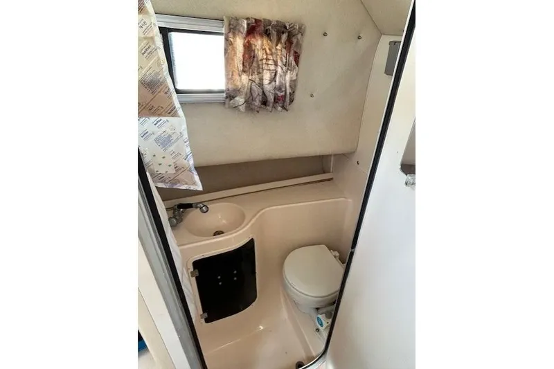 Slide: The Image of 1999 Grady-White Sailfish 272 boat bathroom interior with sink and toilet. - 7