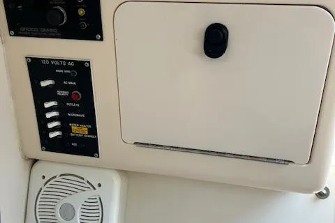 Slide: The Image of Control panel and storage compartment on 1999 Grady-White Sailfish 272 boat. - 9
