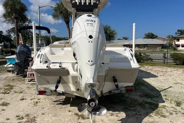 Slide: The Image of 2026 Key West 239 FS boat with powerful 300 HP engine, parked on sandy ground. - 1