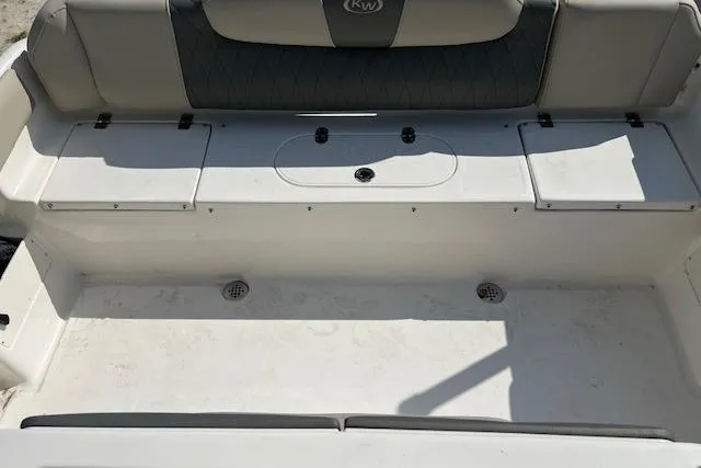 Slide: The Image of 2026 Key West 239 FS boat seating area with storage compartments. - 2