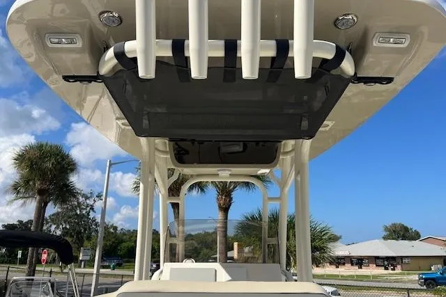 Slide: The Image of 2026 Key West 239 FS boat with T-top and rod holders, parked outdoors. - 8