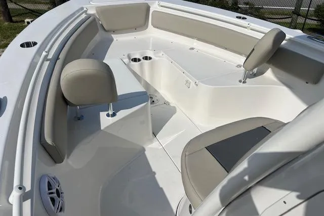 Slide: The Image of 2026 Key West 239 FS boat interior with beige seating and cup holders. - 9