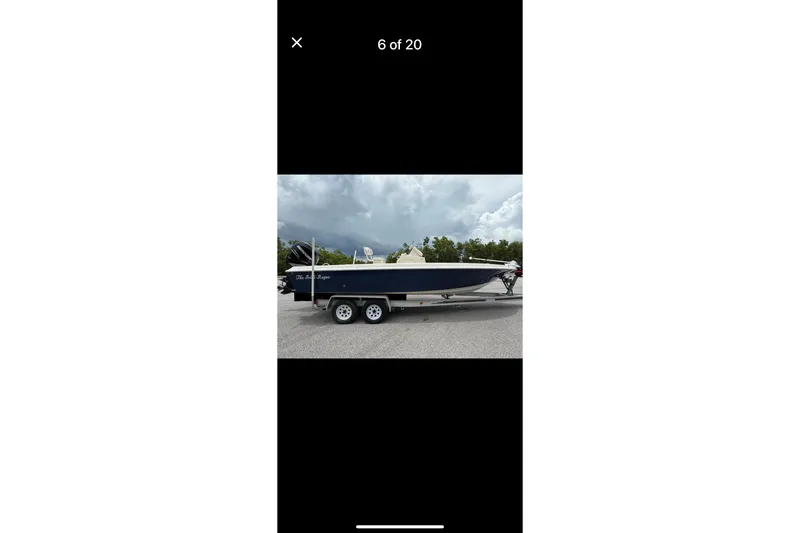 Slide: The Image of 2014 Young Boats 24 Center Console Bay Boat on trailer, parked outdoors. - 5