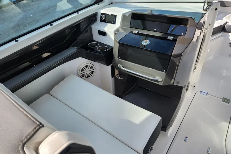 Slide: The Image of 2020 Blackfin 272 DC boat interior with seating, storage, and cup holders. - 12