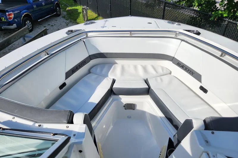 Slide: The Image of 2020 Blackfin 272 DC boat interior with white seating and Blackfin branding. - 13