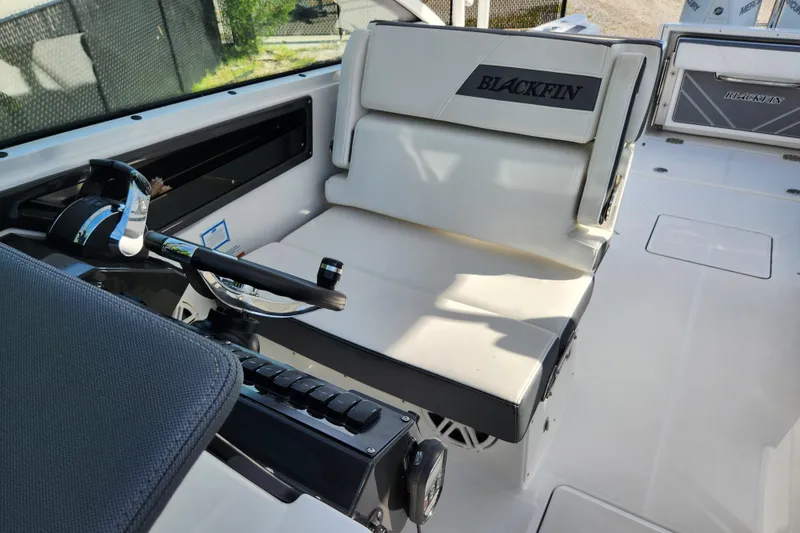 Slide: The Image of 2020 Blackfin 272 DC boat interior with steering wheel and seating area. - 16