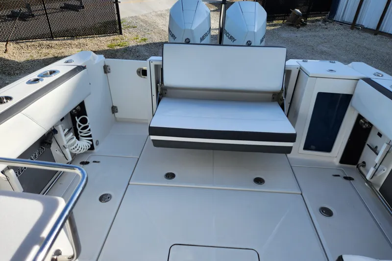 Slide: The Image of 2020 Blackfin 272 DC boat interior with seating and dual Mercury engines. - 19