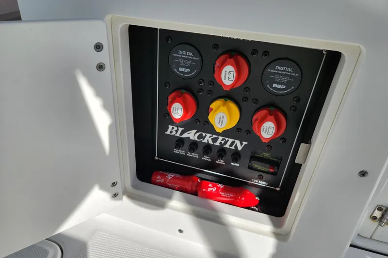 Slide: The Image of Control panel of a 2020 Blackfin 272 DC boat with switches and relays. - 27