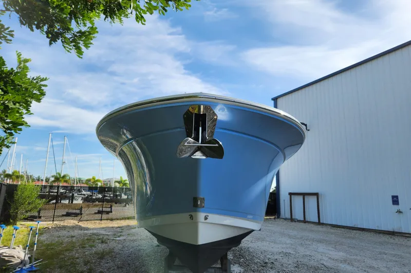 Slide: The Image of 2020 Blackfin 272 DC boat in storage, blue hull, sunny day, marina background. - 3