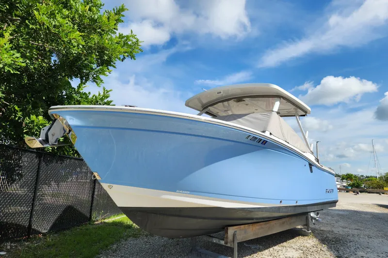 Slide: The Image of 2020 Blackfin 272 DC boat on display under a clear blue sky. - 31