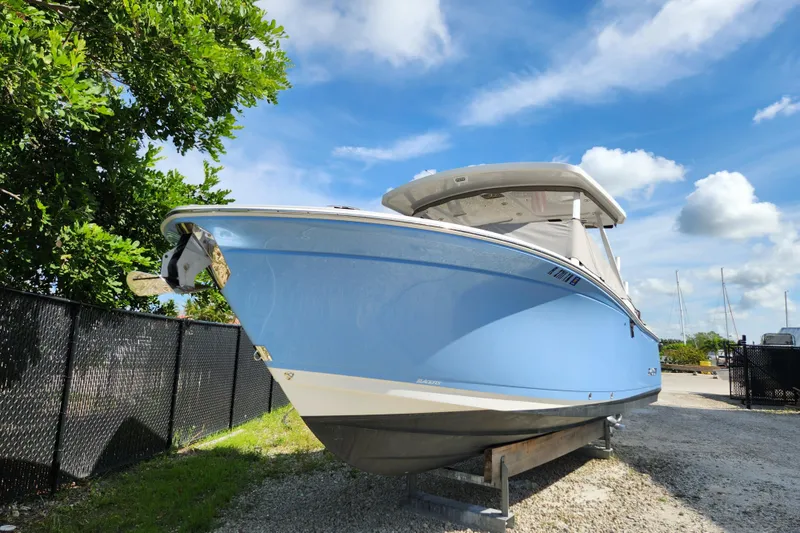 Slide: The Image of 2020 Blackfin 272 DC boat in a marina, blue hull, sunny day. - 32