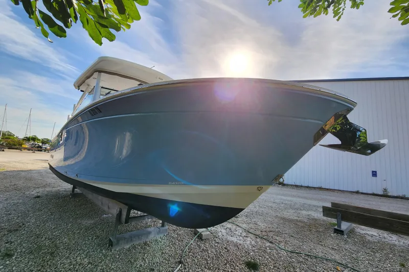 Slide: The Image of 2020 Blackfin 272 DC boat on dry dock under a sunny sky. - 6