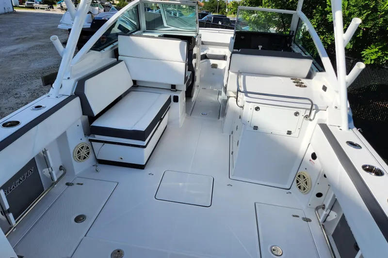 Slide: The Image of 2020 Blackfin 272 DC boat interior with white seating and storage compartments. - 7