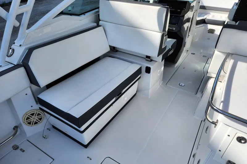 Slide: The Image of 2020 Blackfin 272 DC boat interior with white seating and sleek design. - 8
