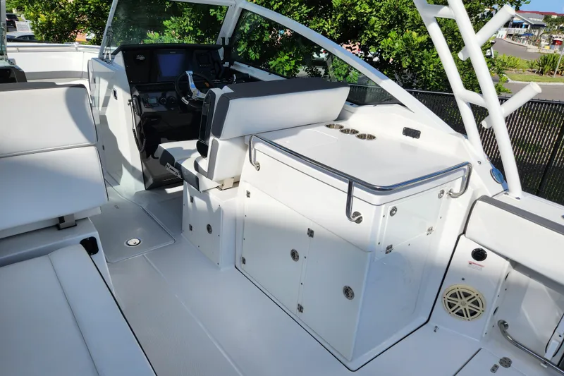 Slide: The Image of 2020 Blackfin 272 DC boat interior with helm, seating, and storage compartments. - 9