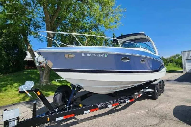 Slide: The Image of 2018 Formula 310 Sun Sport boat docked in a marina, surrounded by other vessels. - 1