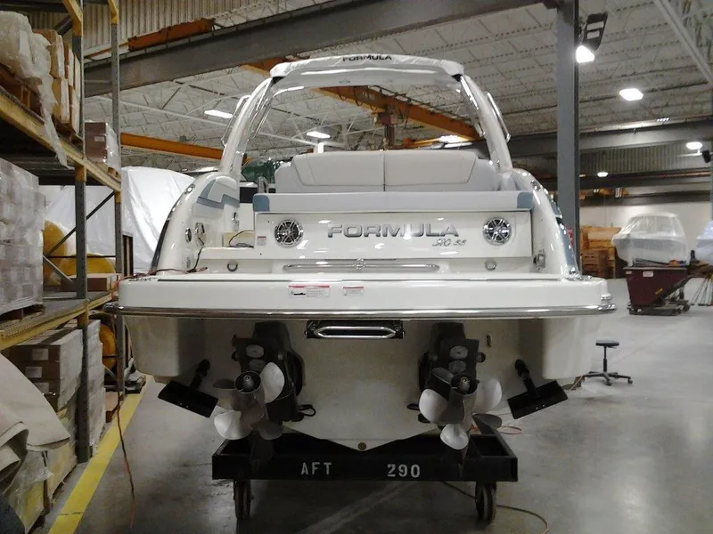 Slide: The Image of Engine compartment of a 2018 Formula 310 Sun Sport boat, featuring a powerful motor. - 11