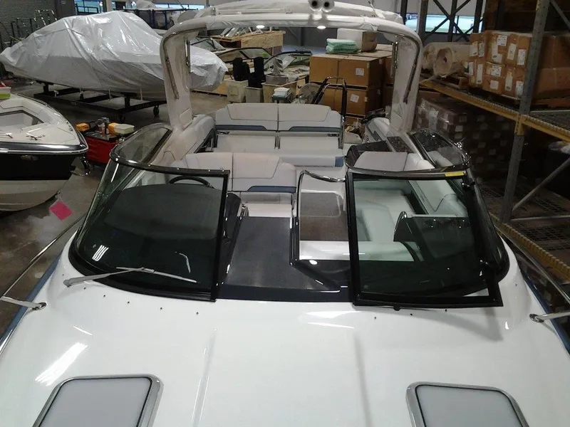 Slide: The Image of 2018 Formula 310 Sun Sport boat in a warehouse, rear view showing dual propellers. - 14