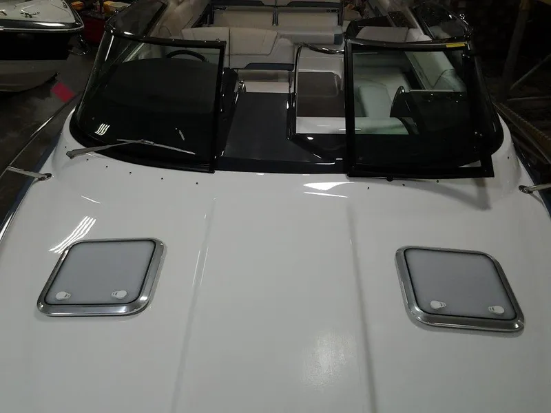 Slide: The Image of 2018 Formula 310 Sun Sport boat in storage, featuring open cockpit and sleek design. - 16