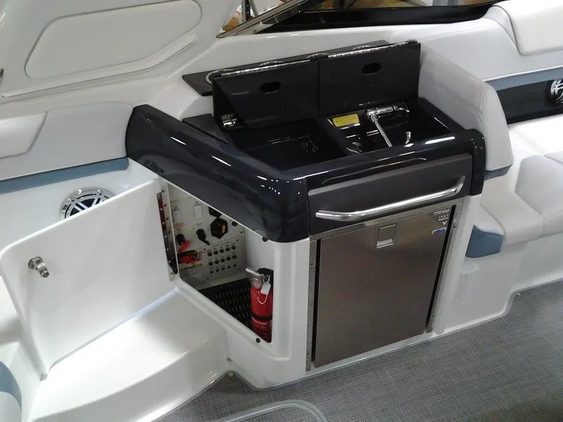 Slide: The Image of 2018 Formula 310 Sun Sport boat deck with hatches and railing in a warehouse setting. - 17