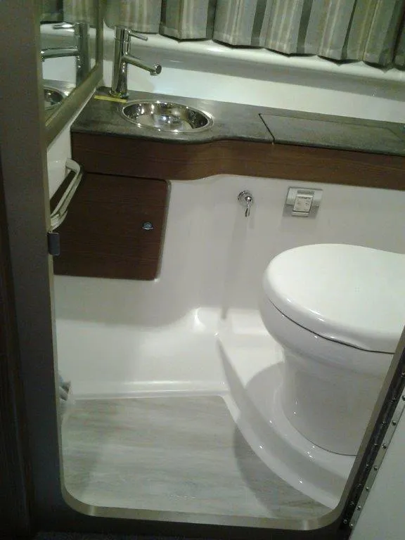 Slide: The Image of 2018 Formula 310 Sun Sport boat interior with white and blue seating. - 24