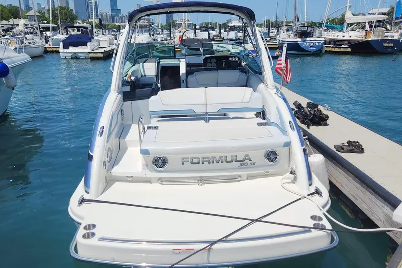 Slide: The Image of Interior of 2018 Formula 310 Sun Sport boat with cushioned seating and wooden table. - 3