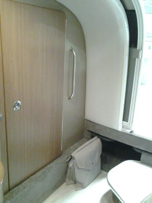 Slide: The Image of 2018 Formula 310 Sun Sport boat interior with white seating and gray flooring. - 30