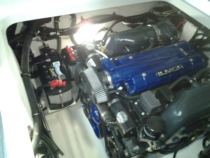 Slide: The Image of 2018 Formula 310 Sun Sport boat on trailer, parked outdoors near a building. - 8