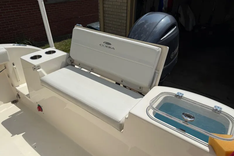 Slide: The Image of 2020 Cobia 220 Center Console boat interior with seating and Yamaha engine. - 11