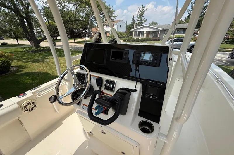 Slide: The Image of 2020 Cobia 220 Center Console boat dashboard with steering wheel and navigation equipment. - 12
