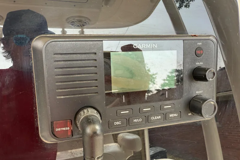 Slide: The Image of Garmin marine radio on 2020 Cobia 220 Center Console boat dashboard. - 16