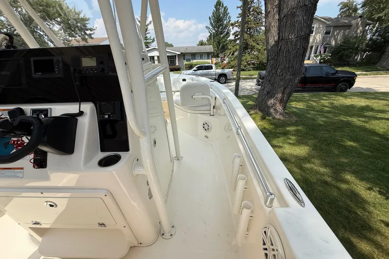 Slide: The Image of 2020 Cobia 220 Center Console boat interior with steering console and rod holders. - 20