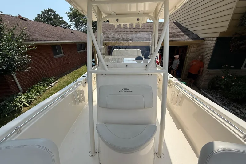 Slide: The Image of 2020 Cobia 220 Center Console boat in a residential driveway, showcasing its sleek design. - 21