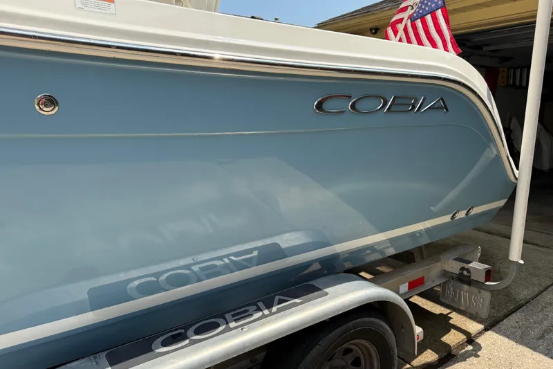 Slide: The Image of 2020 Cobia 220 Center Console boat on trailer with American flag. - 3