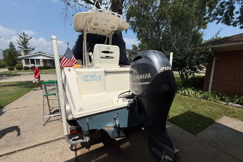 Slide: The Image of 2020 Cobia 220 Center Console boat with Yamaha 200 engine, parked in driveway. - 5