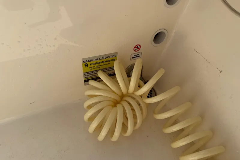 Slide: The Image of Coiled hose and capacity label on 2020 Cobia 220 Center Console boat. - 8