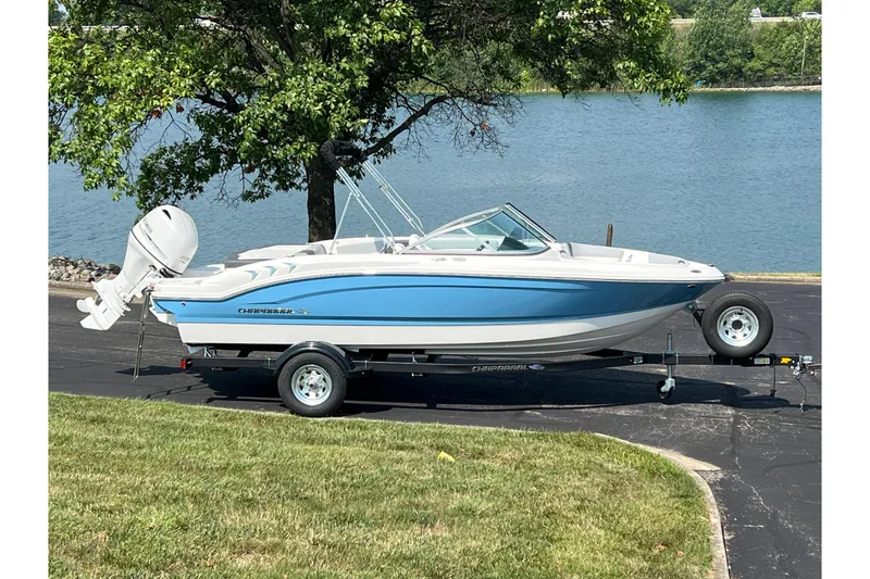 The Image of 2026 CHAPPARAL 19 SSi OB boat on trailer by a lake, under a tree. - 1
