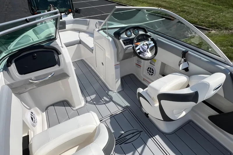 Slide: The Image of 2026 CHAPPARAL 19 SSi OB boat interior with sleek white seating and modern dashboard. - 10