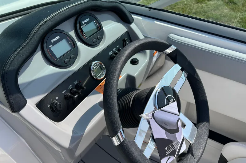 Slide: The Image of 2026 CHAPPARAL 19 SSi OB boat dashboard with Yamaha gauges and steering wheel. - 12