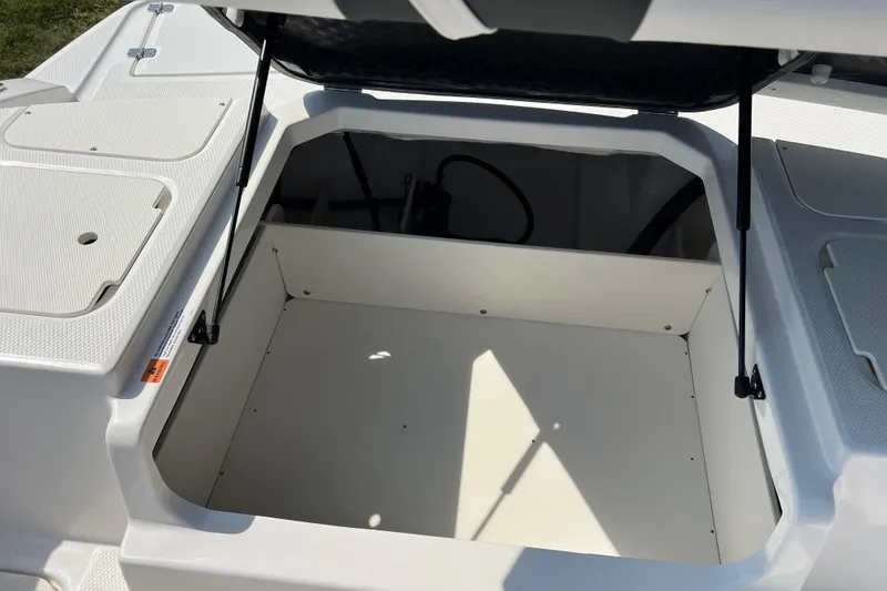 Slide: The Image of Open storage compartment on 2026 CHAPPARAL 19 SSi OB boat, showcasing spacious interior. - 20