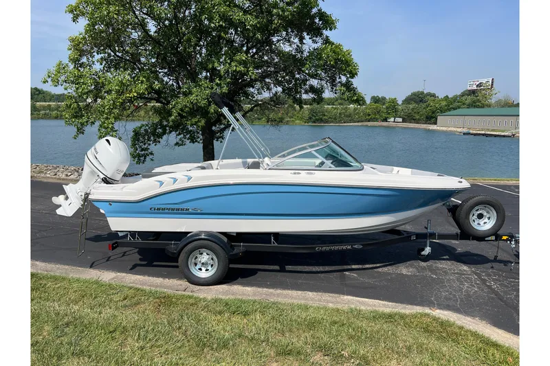 Slide: The Image of 2026 CHAPPARAL 19 SSi OB boat on trailer by a lake, under a tree. - 4