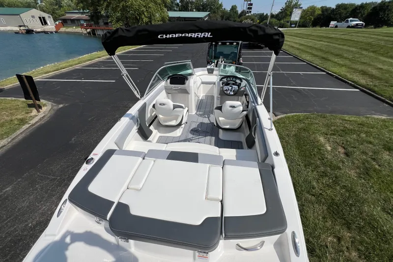 Slide: The Image of 2026 CHAPPARAL 19 SSi OB boat with sleek interior, parked near a lake. - 7