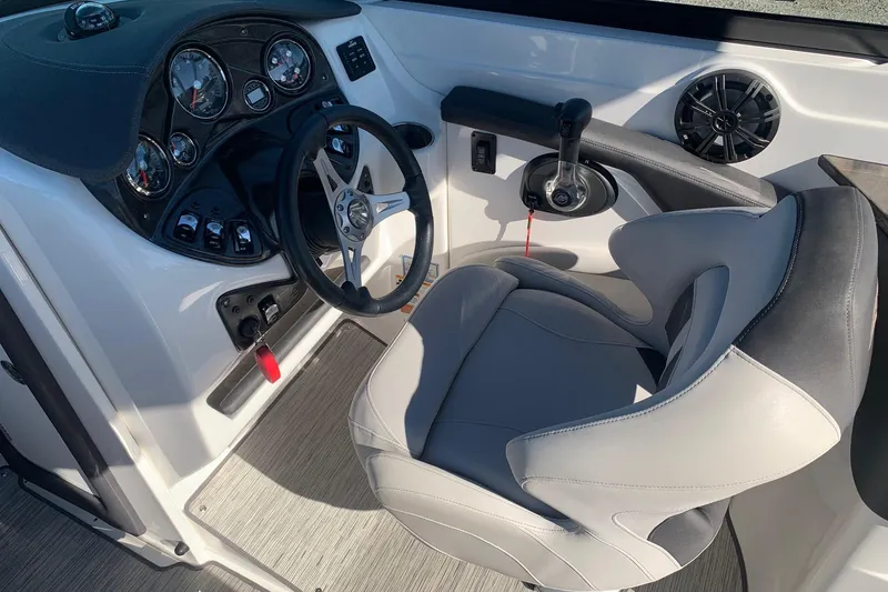 Slide: The Image of 2018 Rinker QX26 BR boat cockpit with steering wheel and control panel. - 12