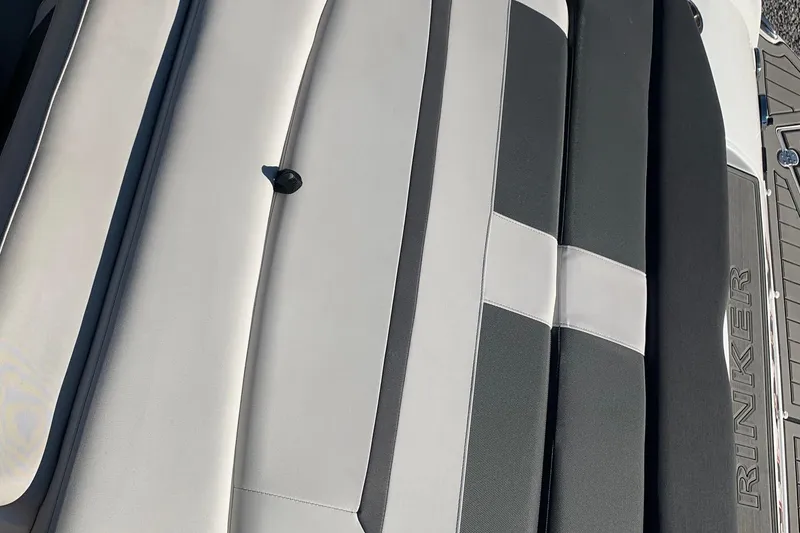 Slide: The Image of 2018 Rinker QX26 BR boat seating with sleek black and white upholstery design. - 14