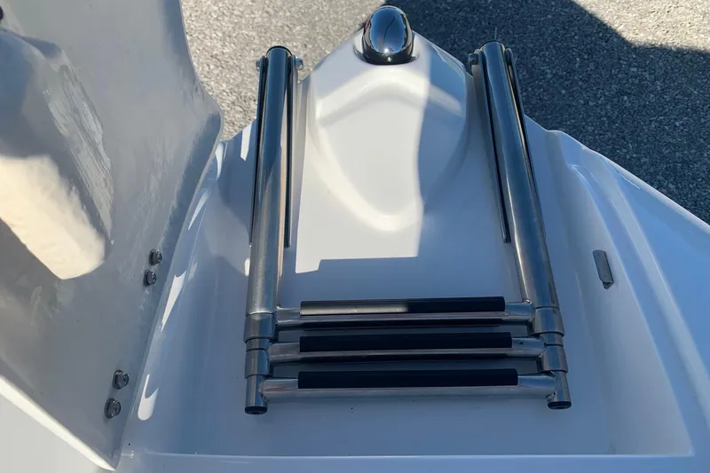 Slide: The Image of 2018 Rinker QX26 BR boat ladder, stainless steel, folded on deck. - 16