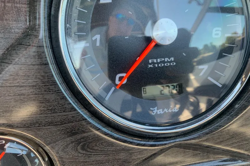 Slide: The Image of Close-up of 2018 Rinker QX26 BR tachometer showing RPM and digital display. - 18