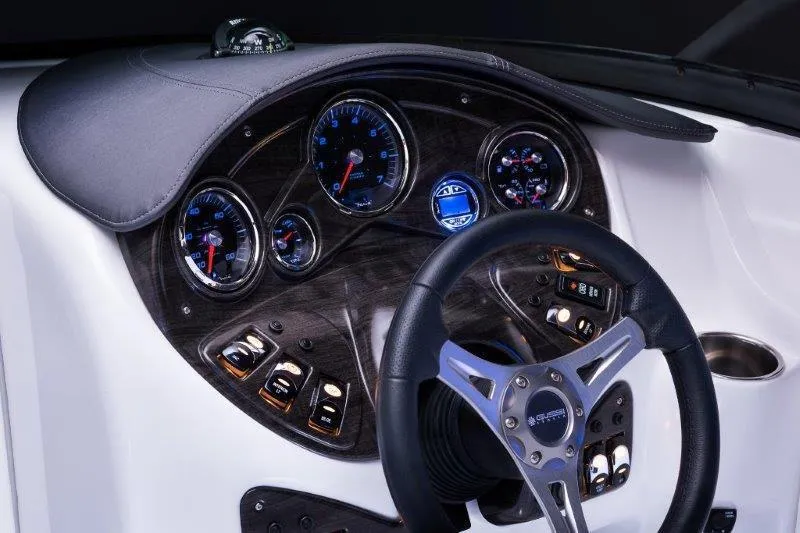 Slide: The Image of Manufacturer Provided Image: 2018 Rinker QX26 BR boat dashboard with gauges and steering wheel. - 26