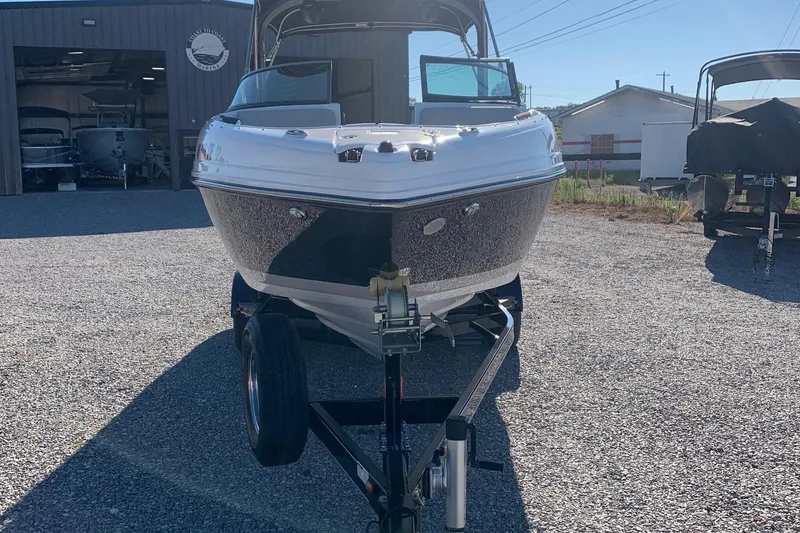 Slide: The Image of 2018 Rinker QX26 BR boat on trailer in outdoor storage area. - 4