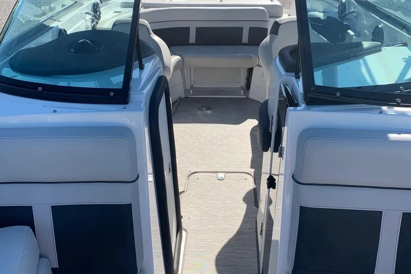 Slide: The Image of 2018 Rinker QX26 BR boat interior with seating and open deck view. - 7