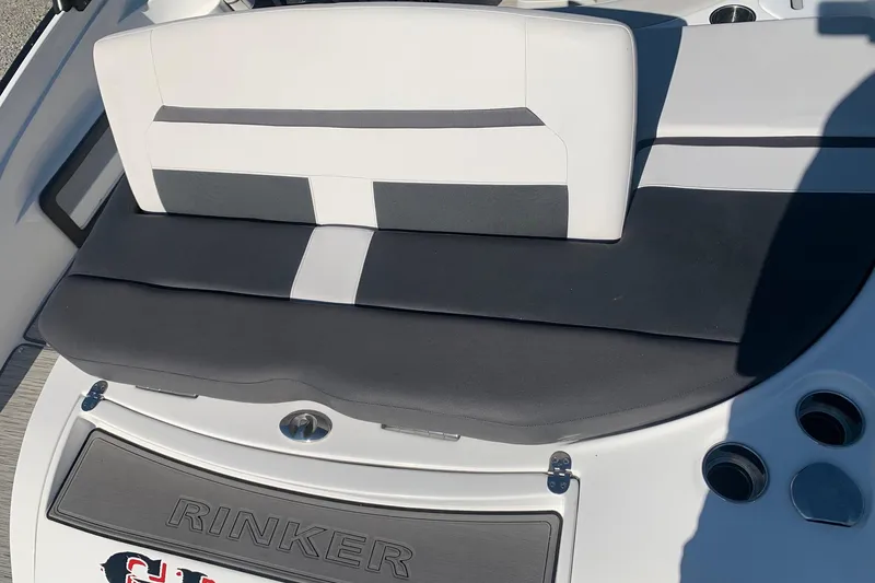Slide: The Image of 2018 Rinker QX26 BR boat seating area with black and white upholstery. - 8